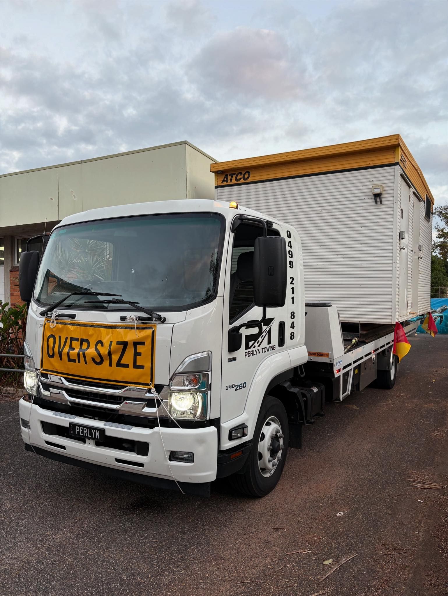 An Oversize Load Truck is Driving Down a Highway — Perlyn Towing in Rockhampton City, QLD