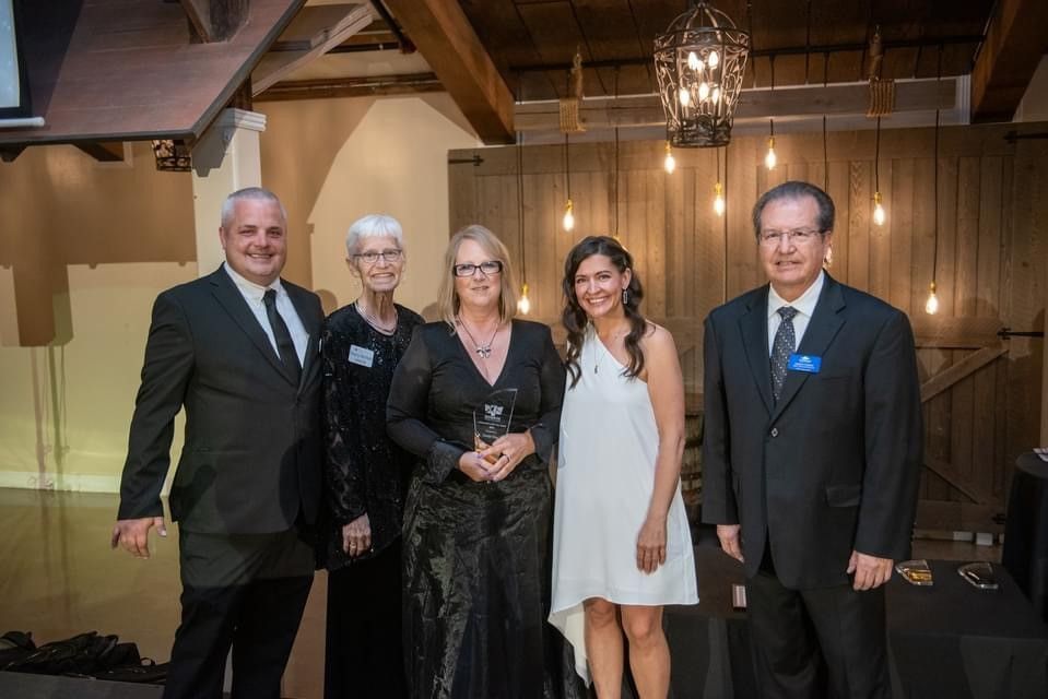 A group of people standing next to each other in a room.