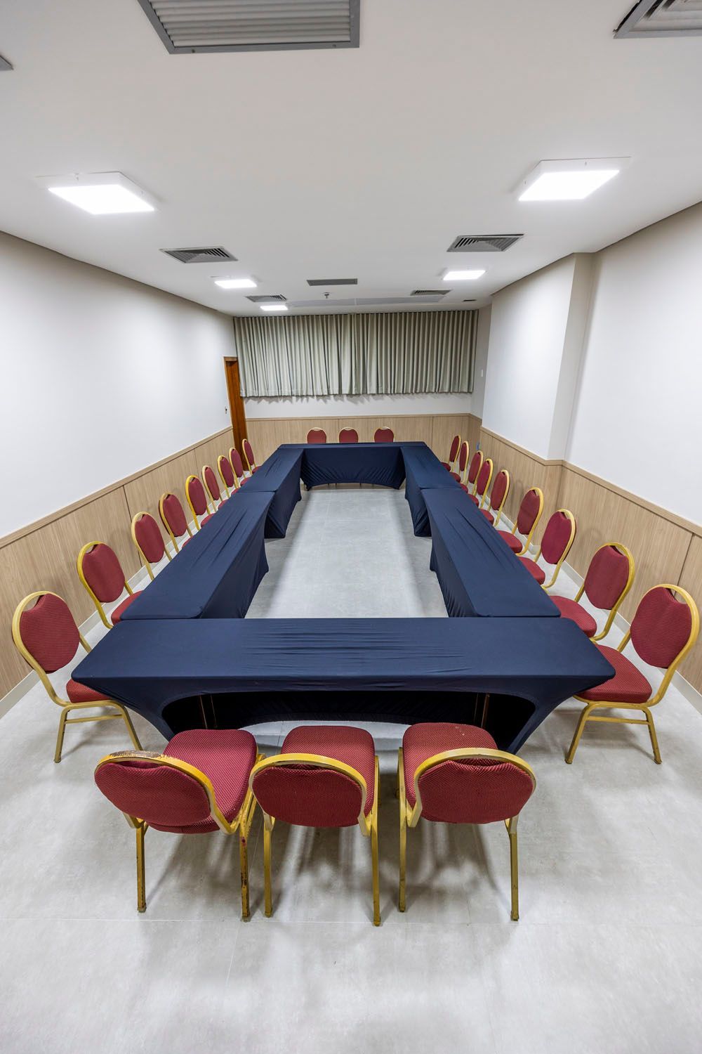 Uma sala de conferências com uma mesa longa e cadeiras