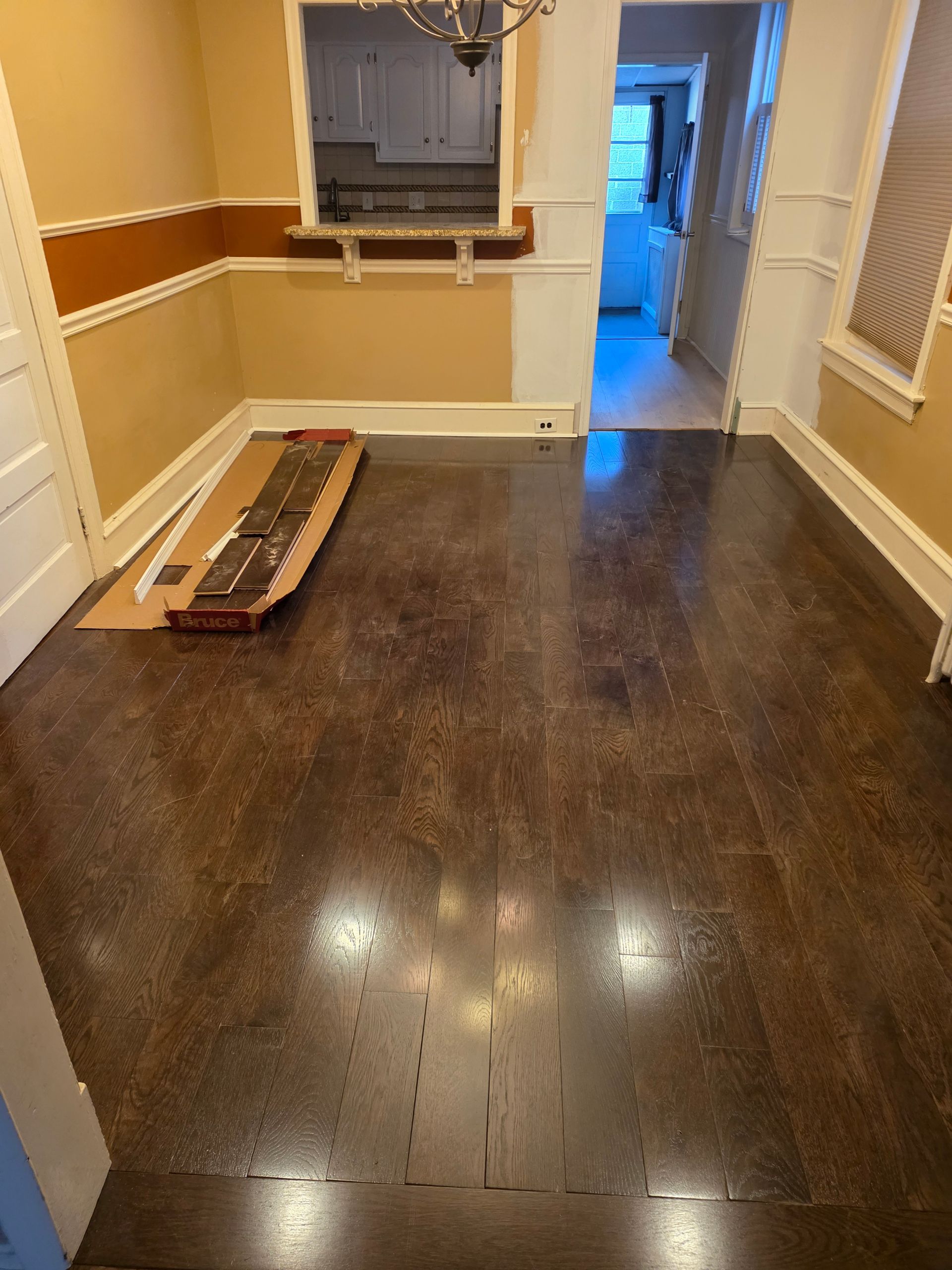 White brick fireplace with a wooden mantle and hearth. Brown wooden ceiling and flooring.
