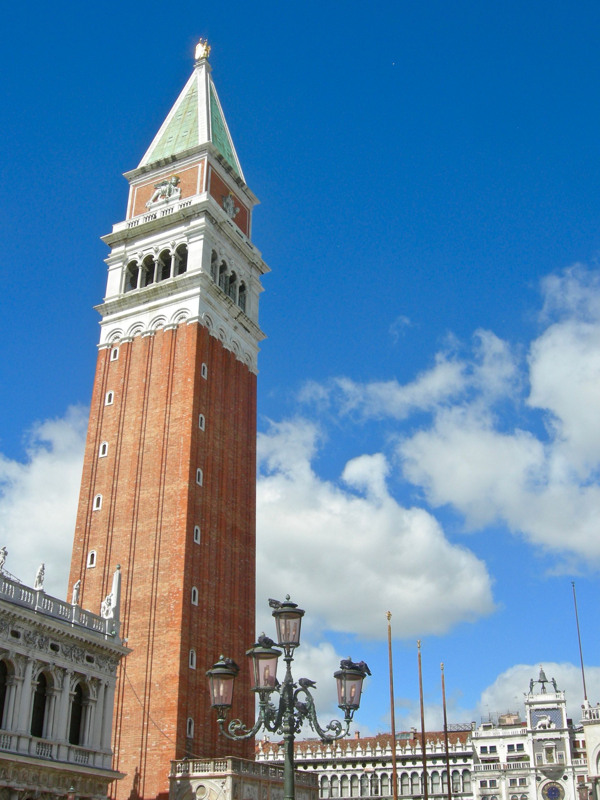A tall brick tower with a clock on top of it