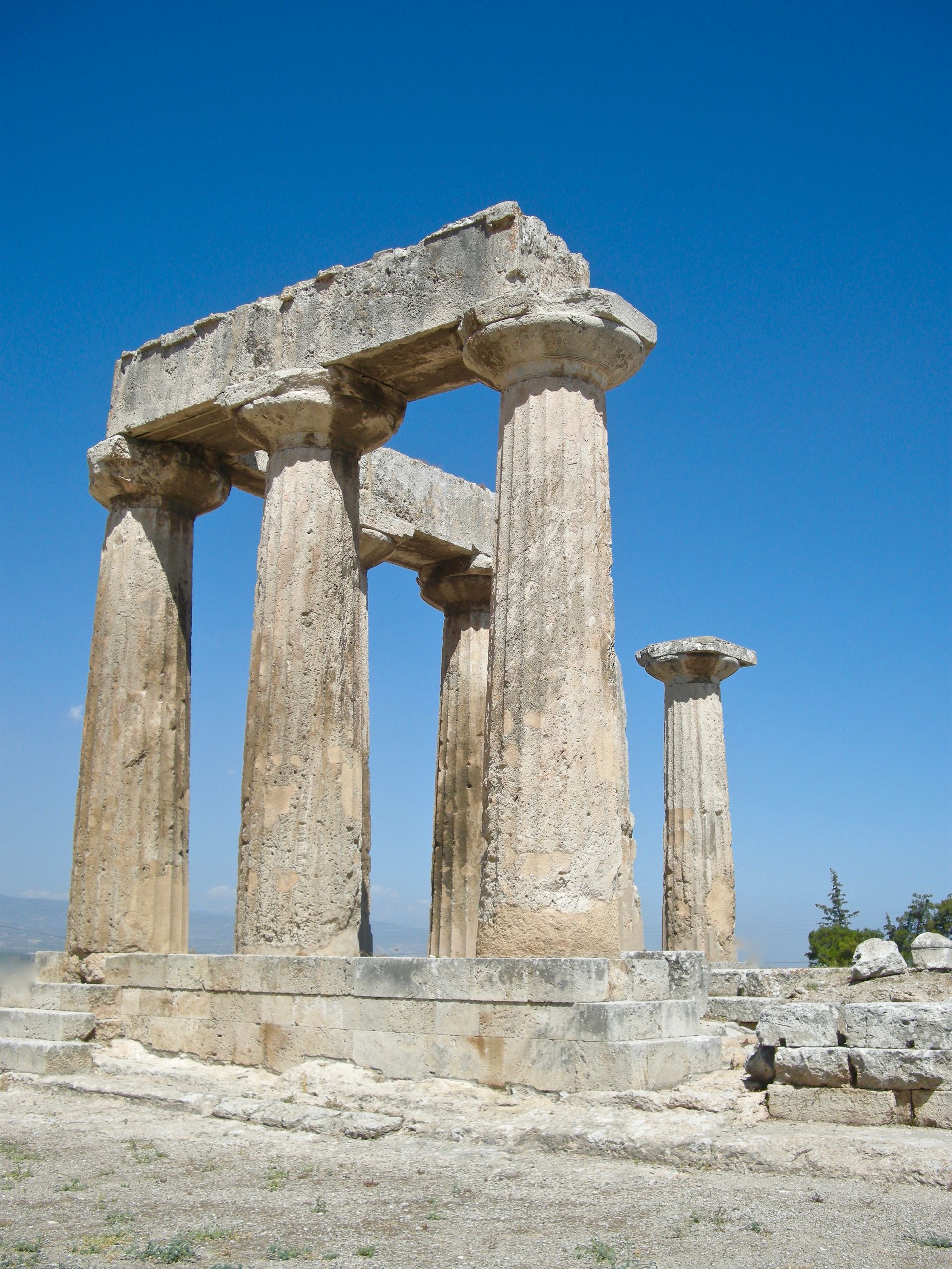 A row of stone columns against a blue sky