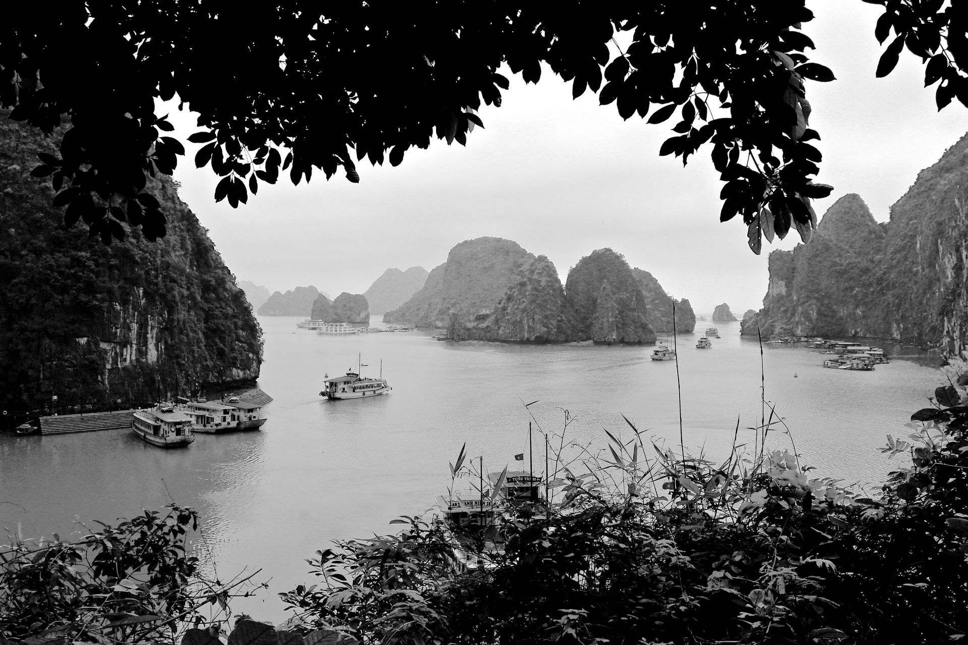 A black and white photo of a body of water surrounded by mountains