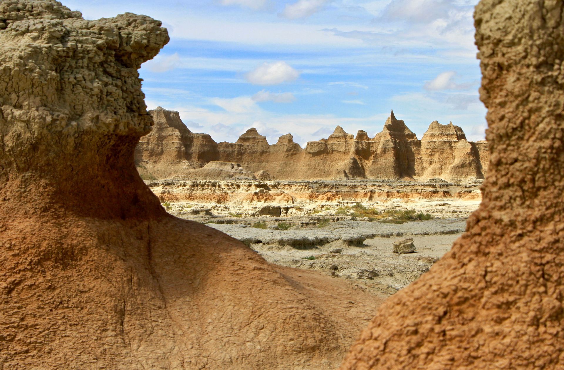 A desert landscape with rocks and mountains in the background