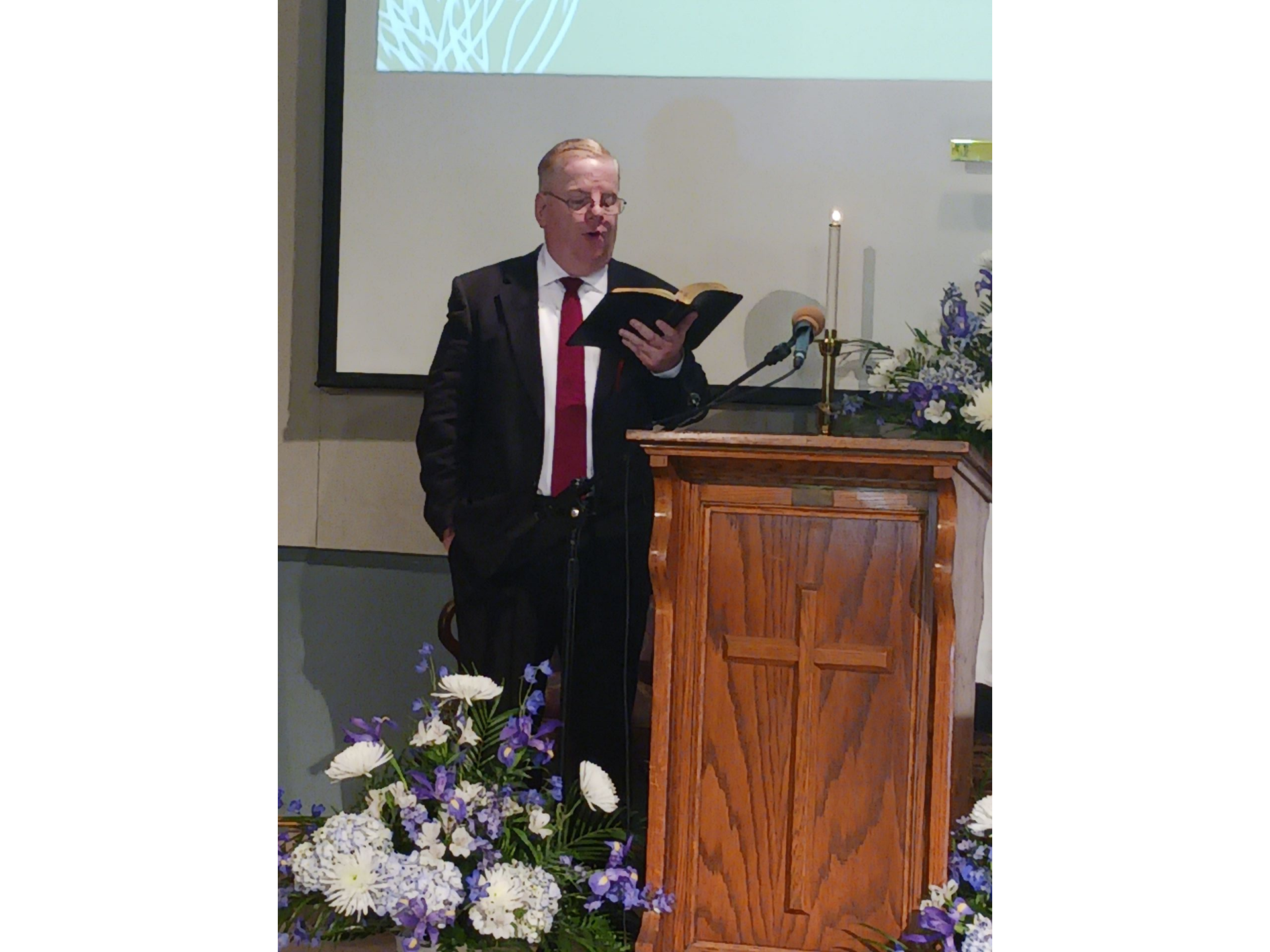 Pastor Tom preaching during Sunday services