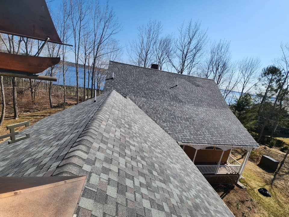 An aerial view of a house with a roof that has shingles on it.