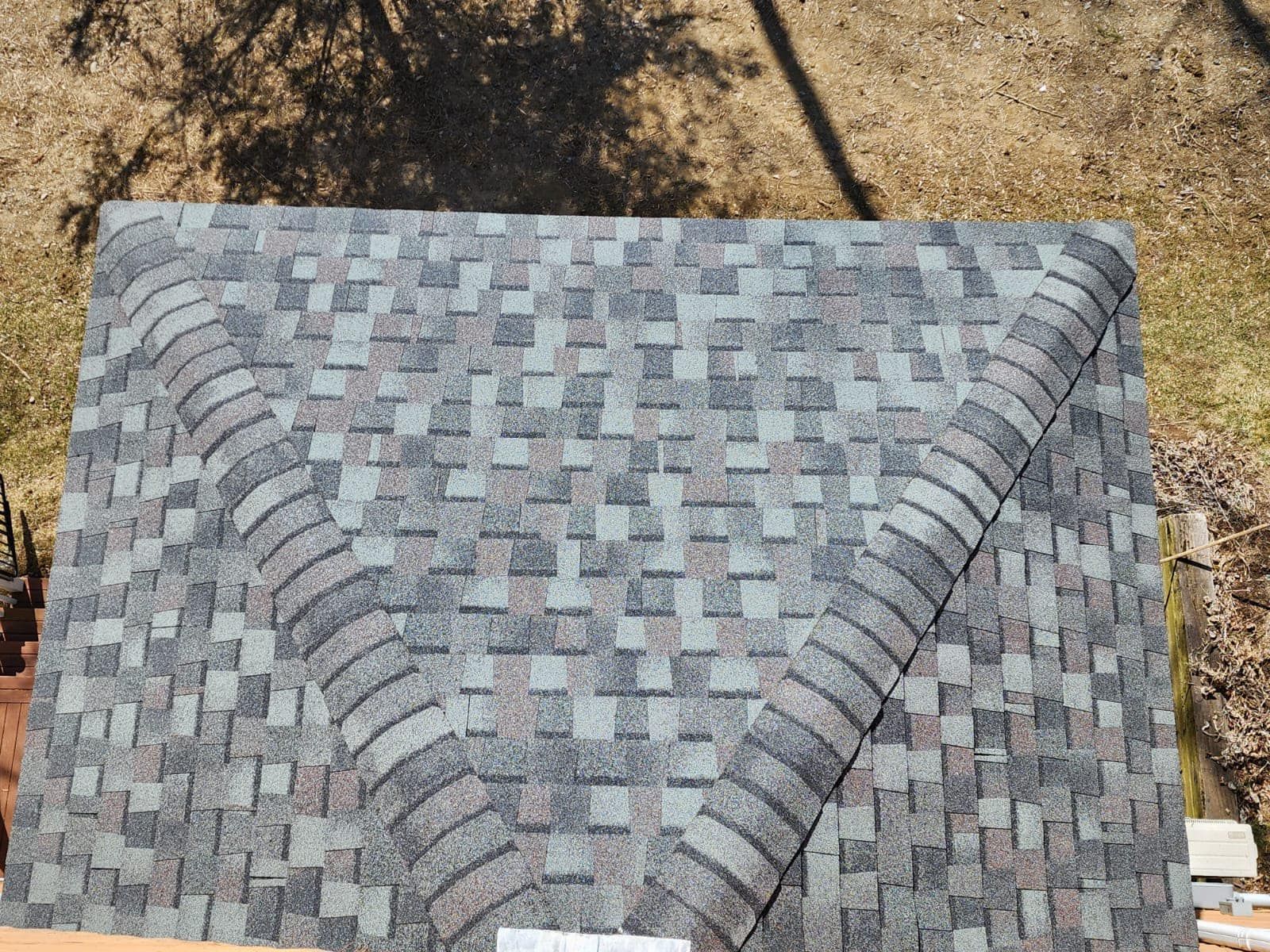 An aerial view of a roof with shingles on it.