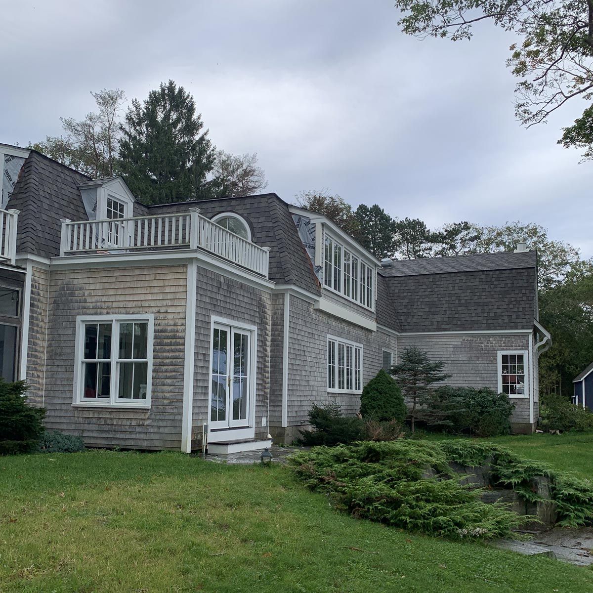 A large house with a balcony on top of it