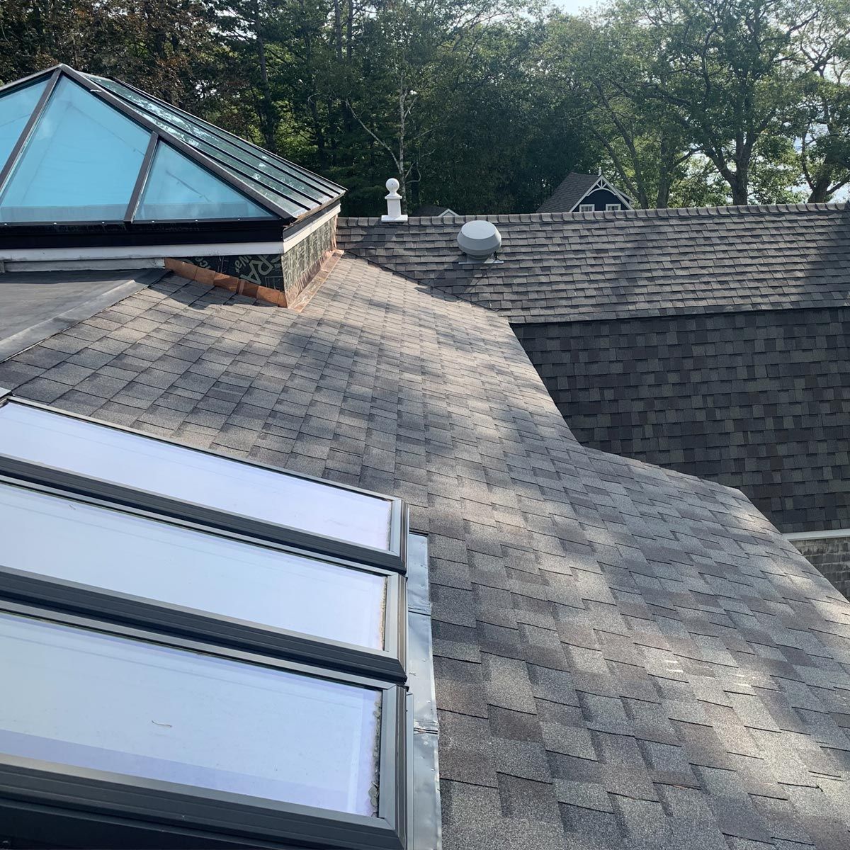 There are two skylights on the roof of a house.