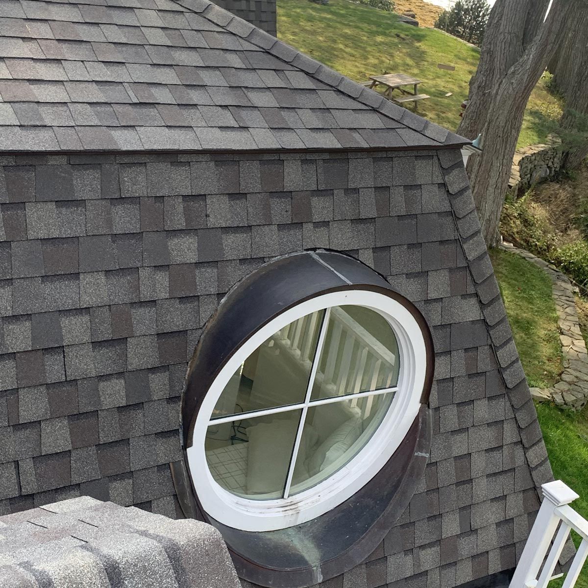 A round window on the roof of a house