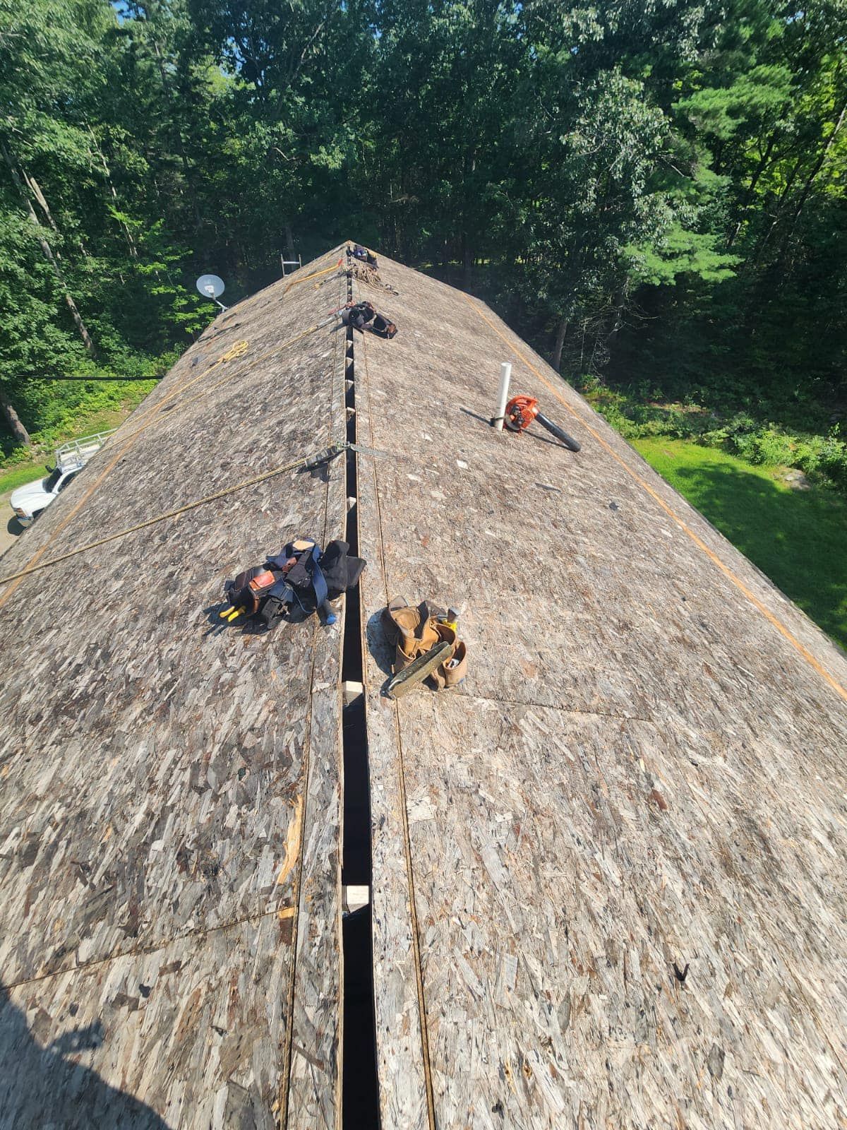 A wooden roof with a lot of tools on it.