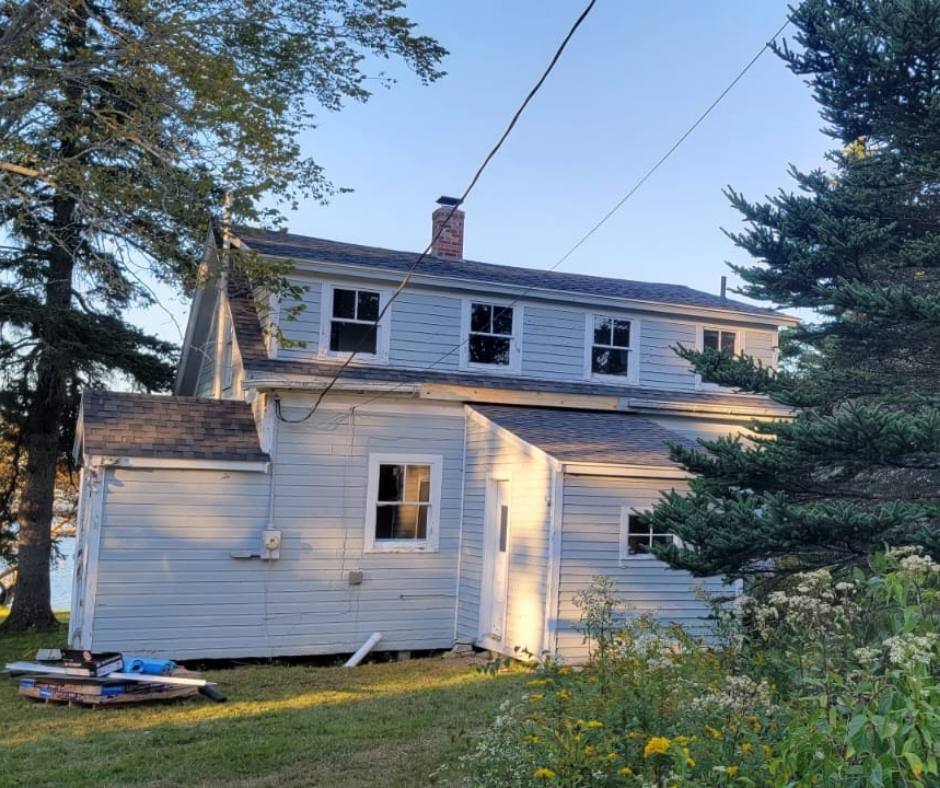 A house with a lot of windows and a chimney