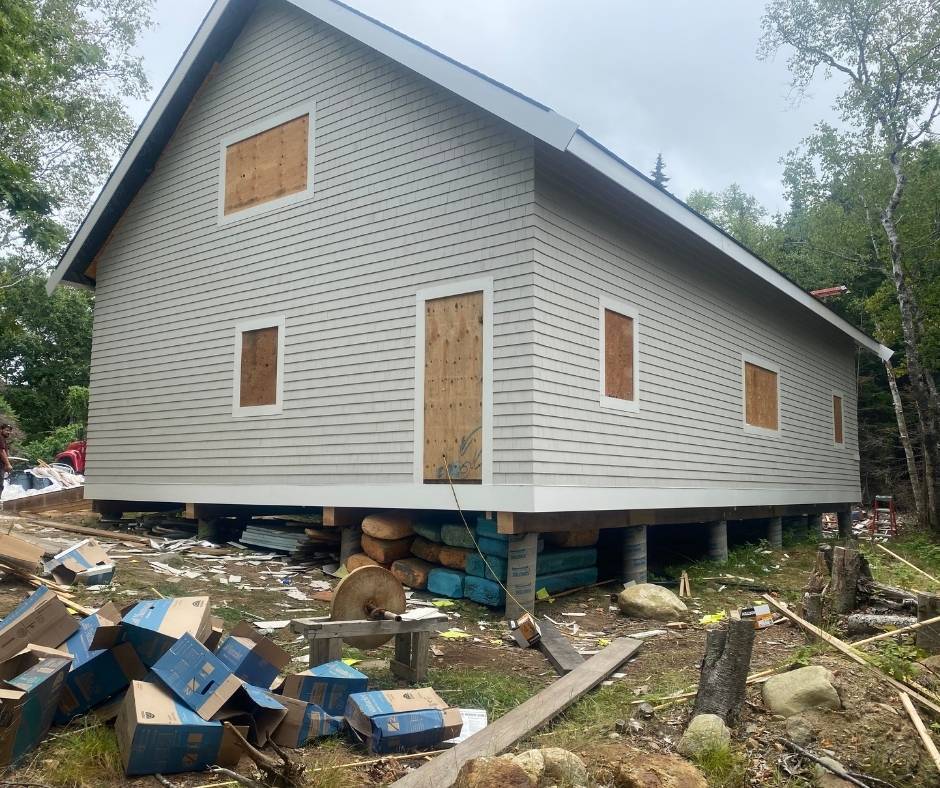 A house with a lot of boxes on the ground in front of it