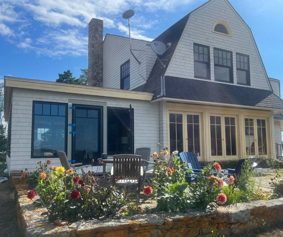 A large white house with a satellite dish on the roof