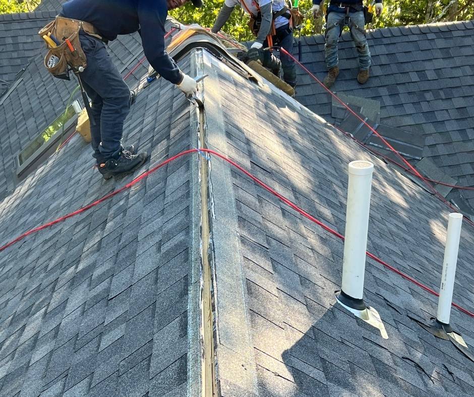 A group of men are working on a roof.