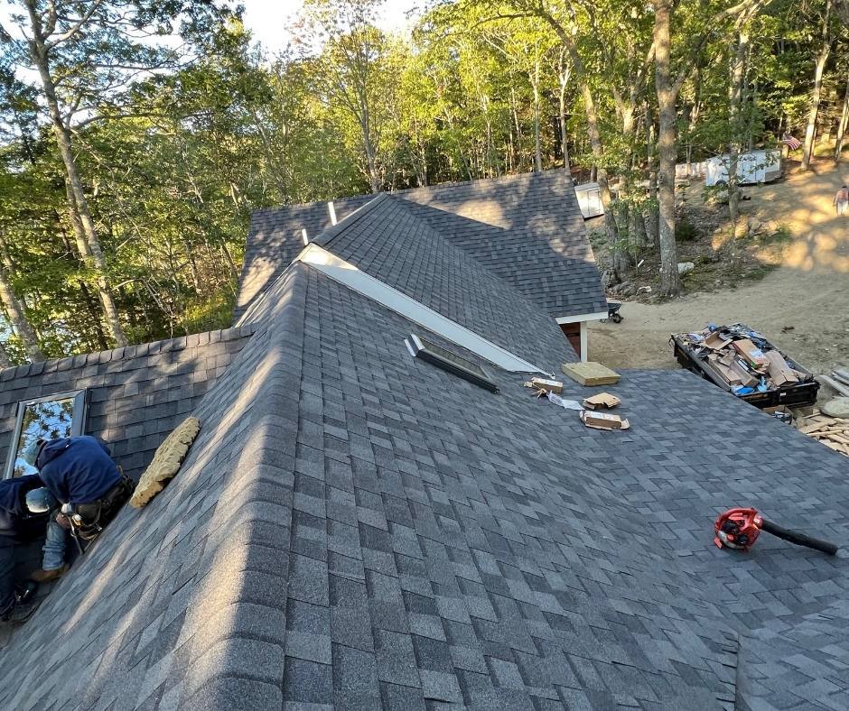 A man is working on the roof of a house.