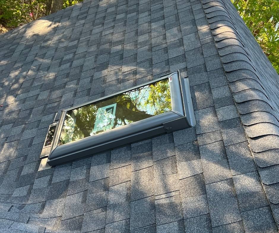 A skylight is sitting on top of a roof.