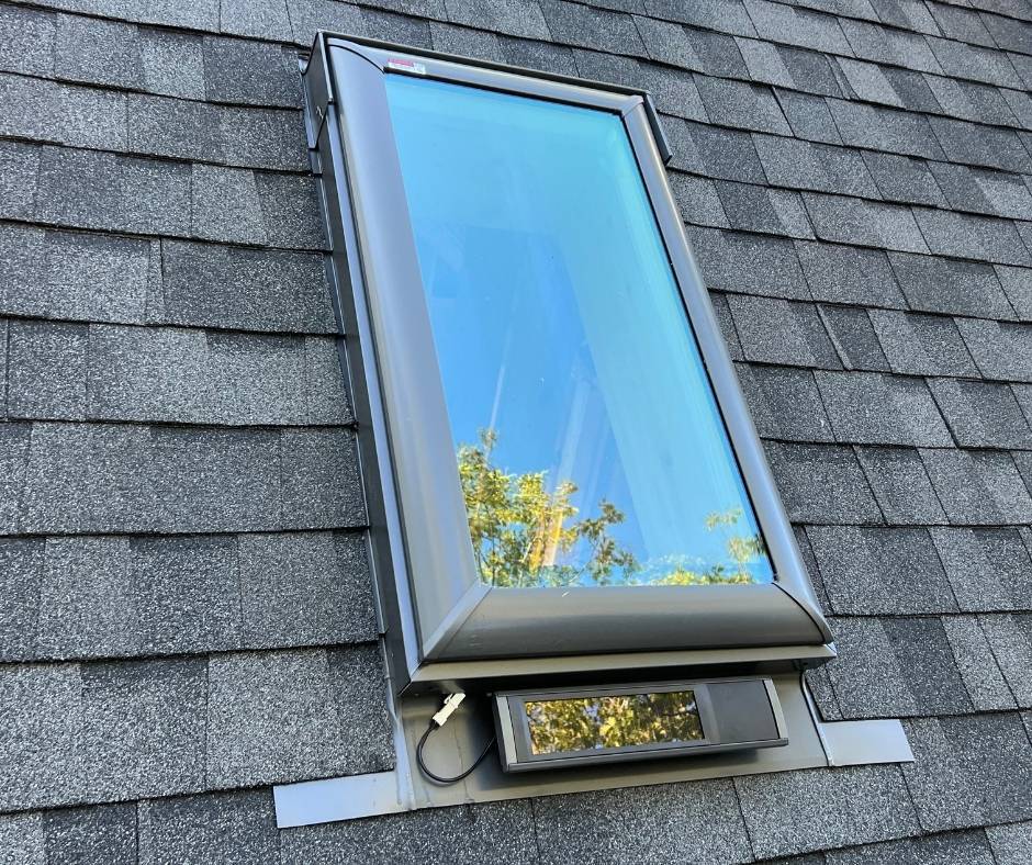 A skylight is sitting on top of a roof.
