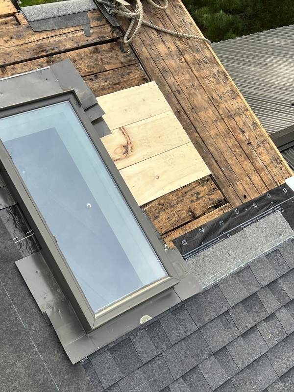 A skylight is being installed on the roof of a house.