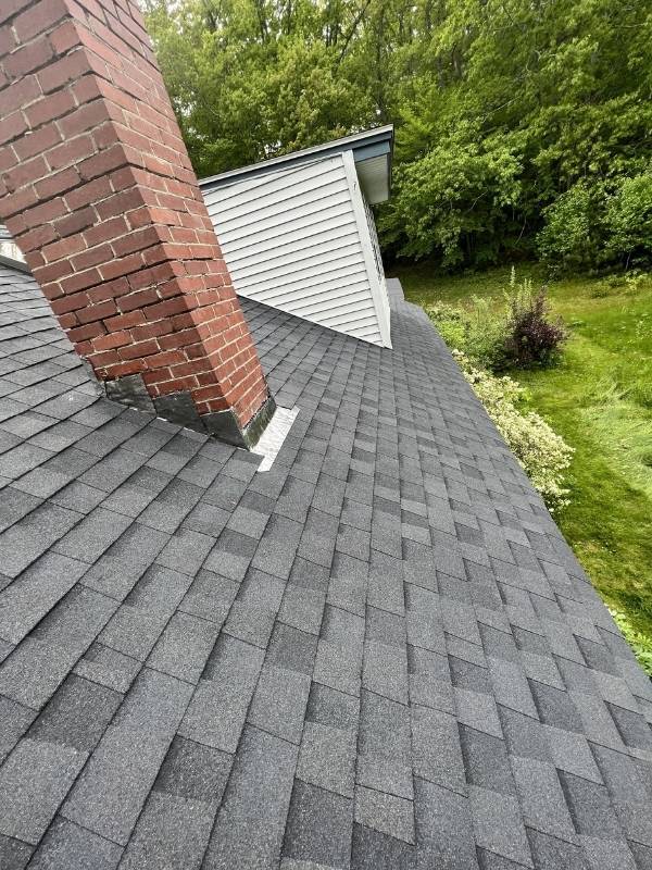 There is a chimney on the roof of a house.