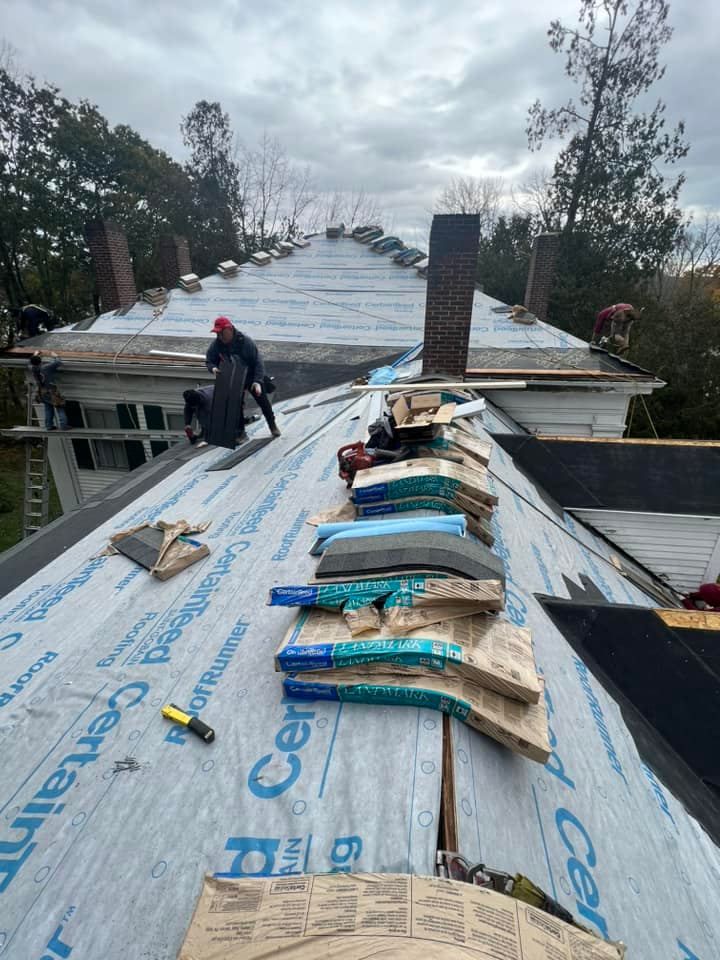 A roof with a lot of tools on it is being repaired.