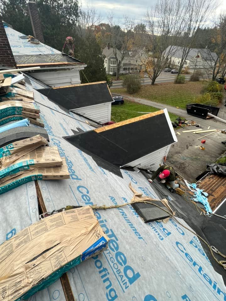 A roof with a lot of shingles on it is being repaired.