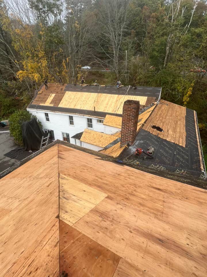 An aerial view of a house with a wooden roof under construction.