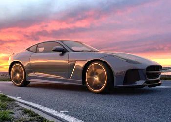 A sports car is parked on the side of the road at sunset.