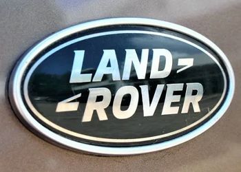 A close up of a land rover logo on a car