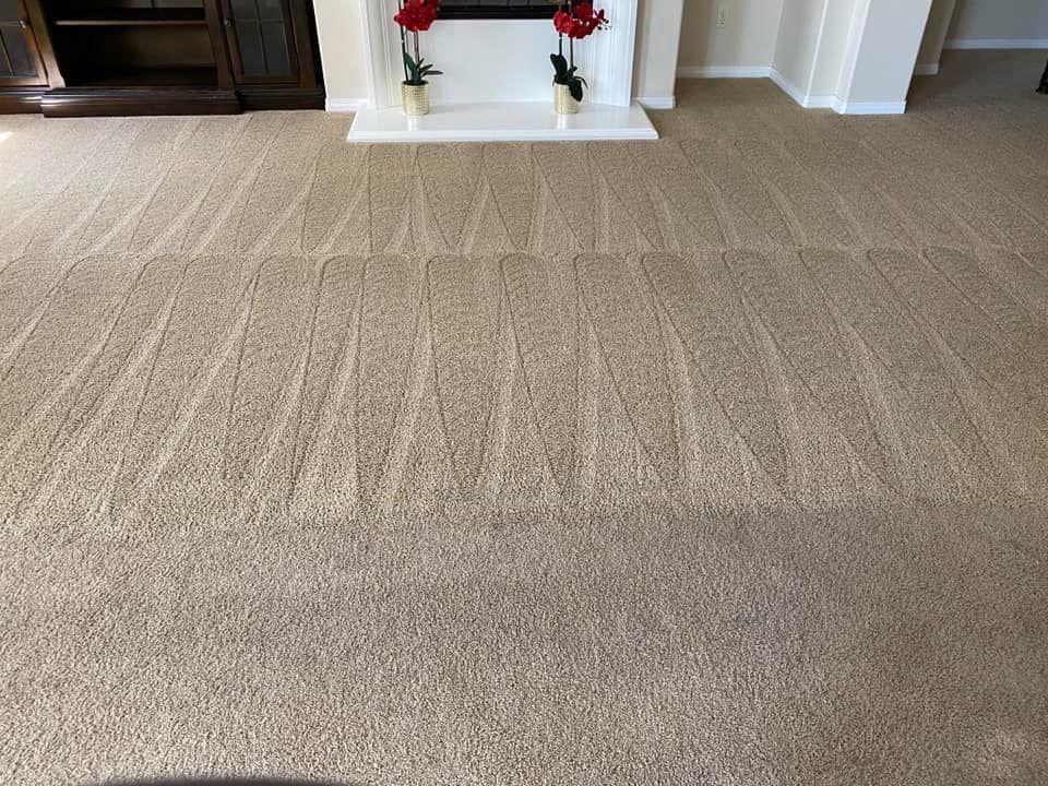 A living room with a fireplace and a carpeted floor.