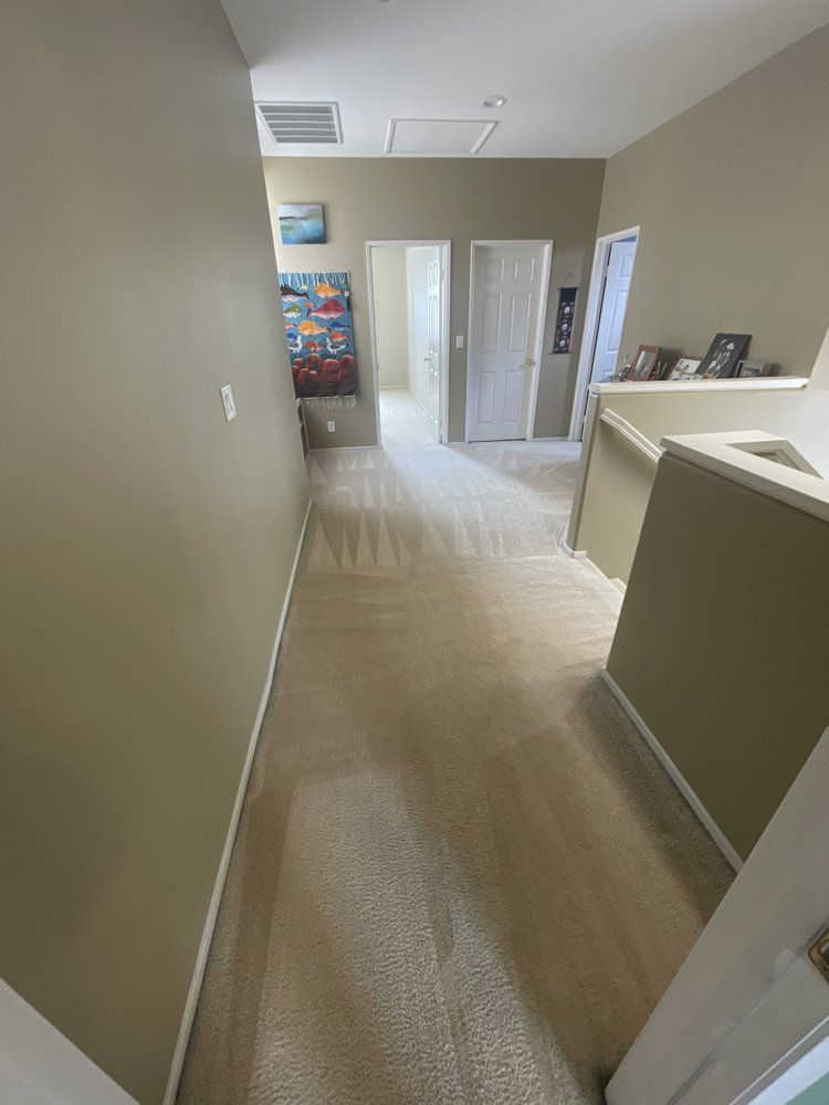 A hallway in a house with a painting on the wall