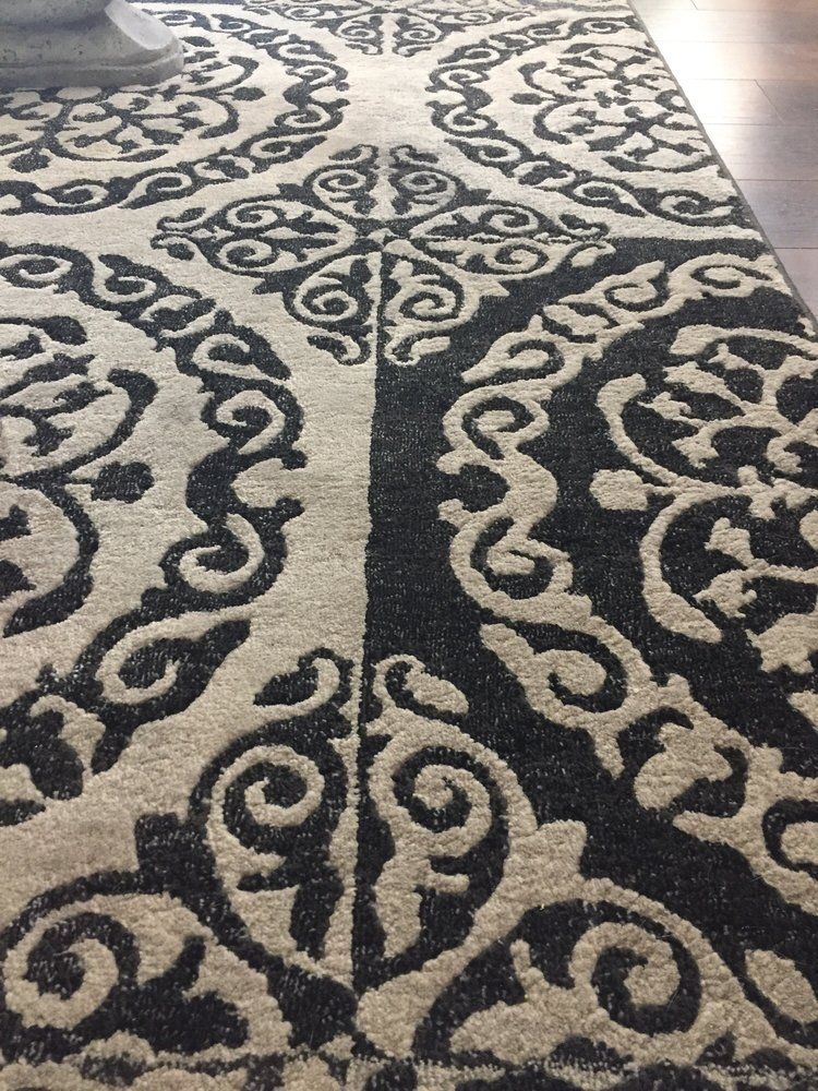 A black and white rug with a pattern on it