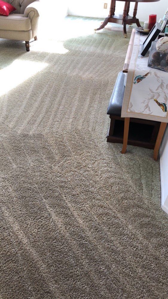 A living room filled with furniture and a carpeted floor.