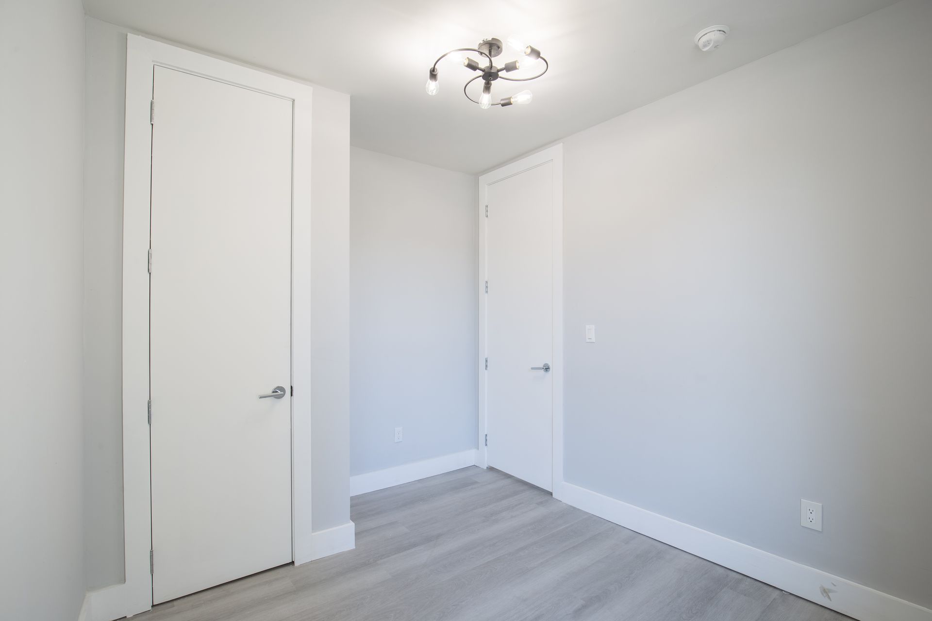 There is a chandelier in the ceiling of the room.