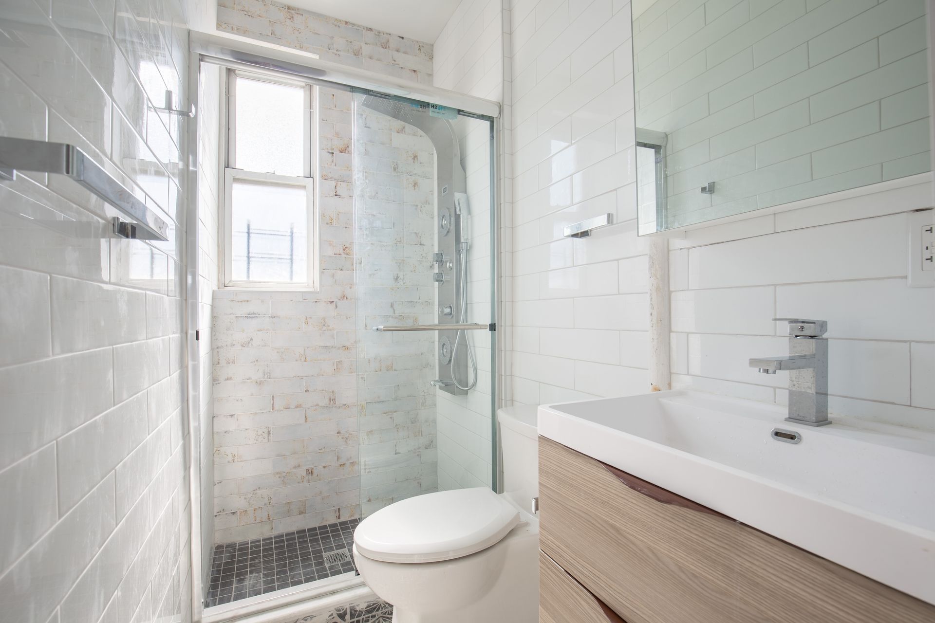 A bathroom with a toilet , sink , and shower.