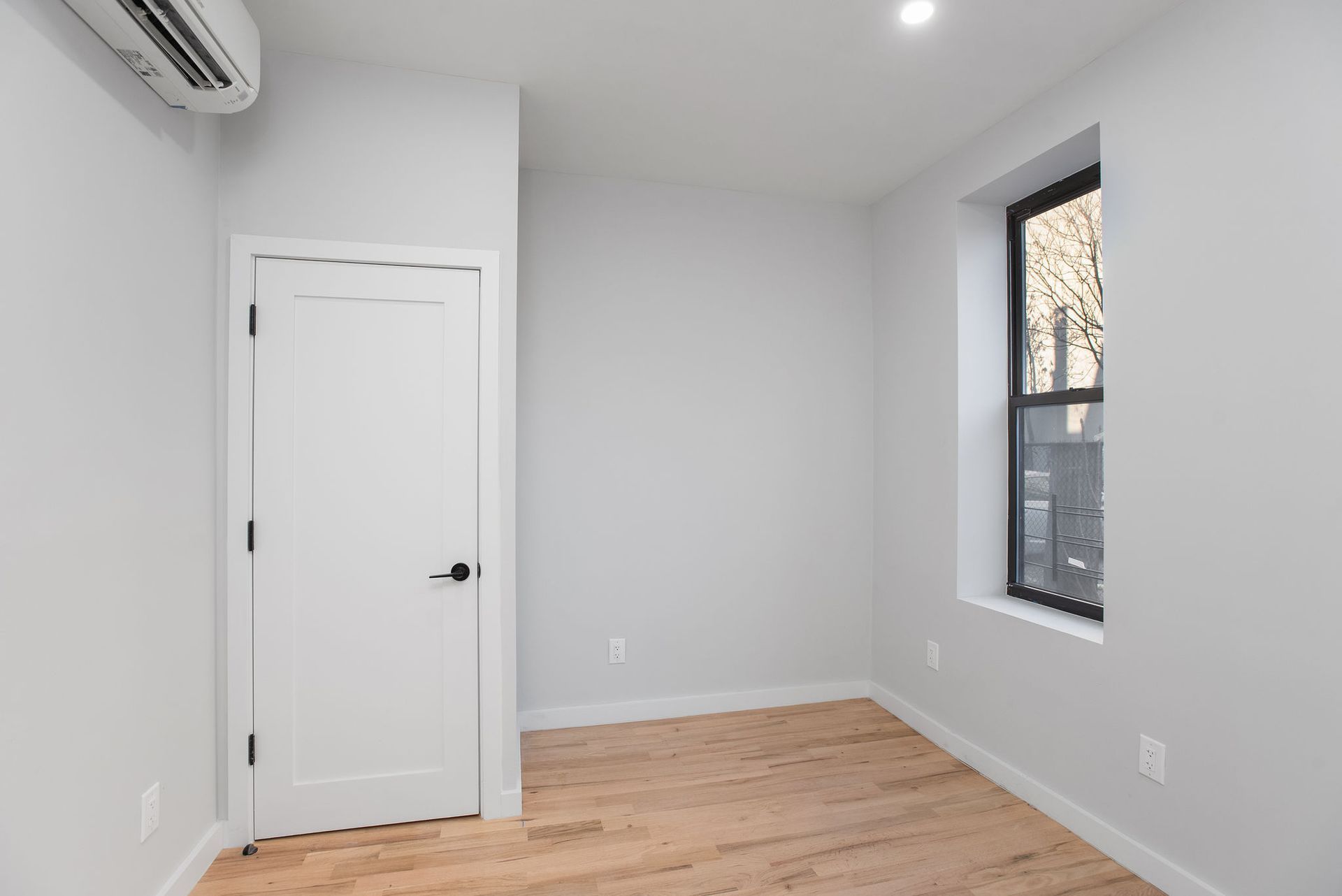 An empty room with a window and a door