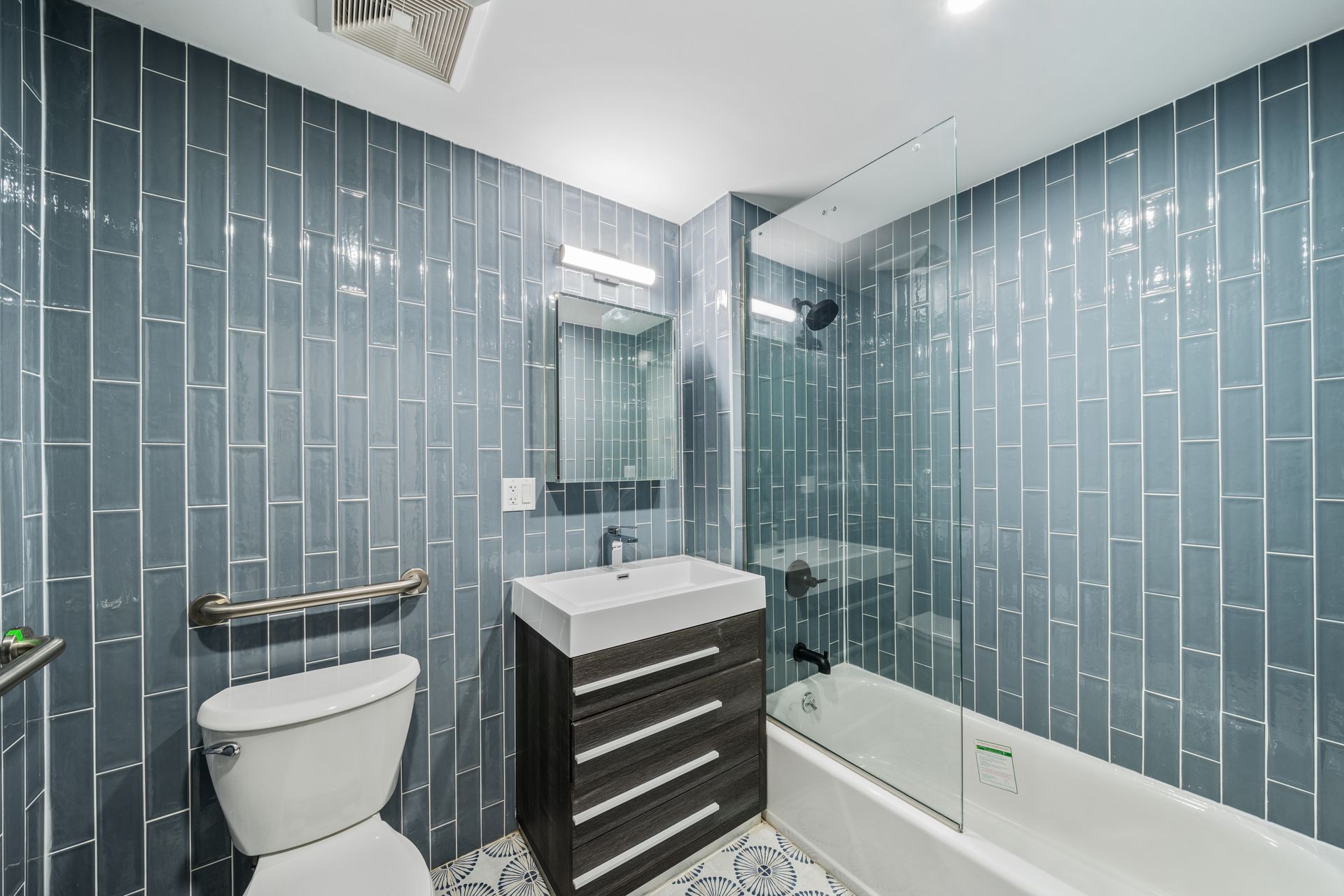 A bathroom with a toilet , sink , and bathtub.