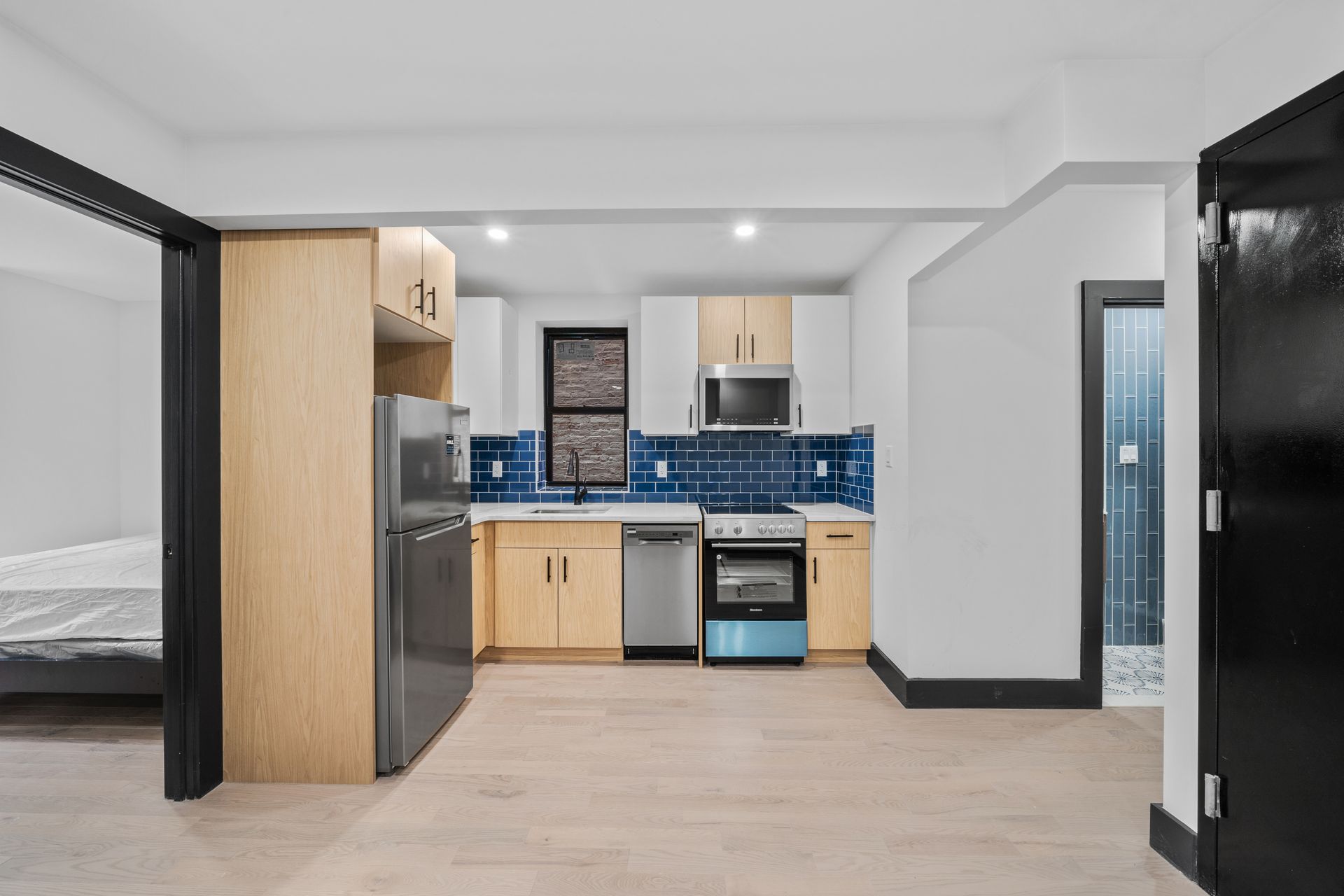 A kitchen with stainless steel appliances and wooden cabinets