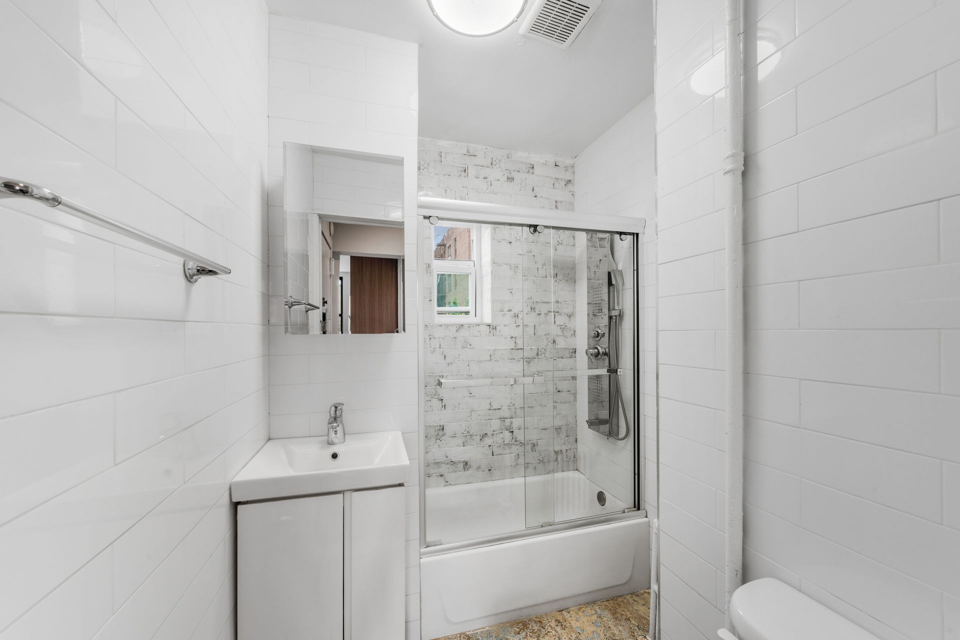 A bathroom with a sink , toilet , and shower.