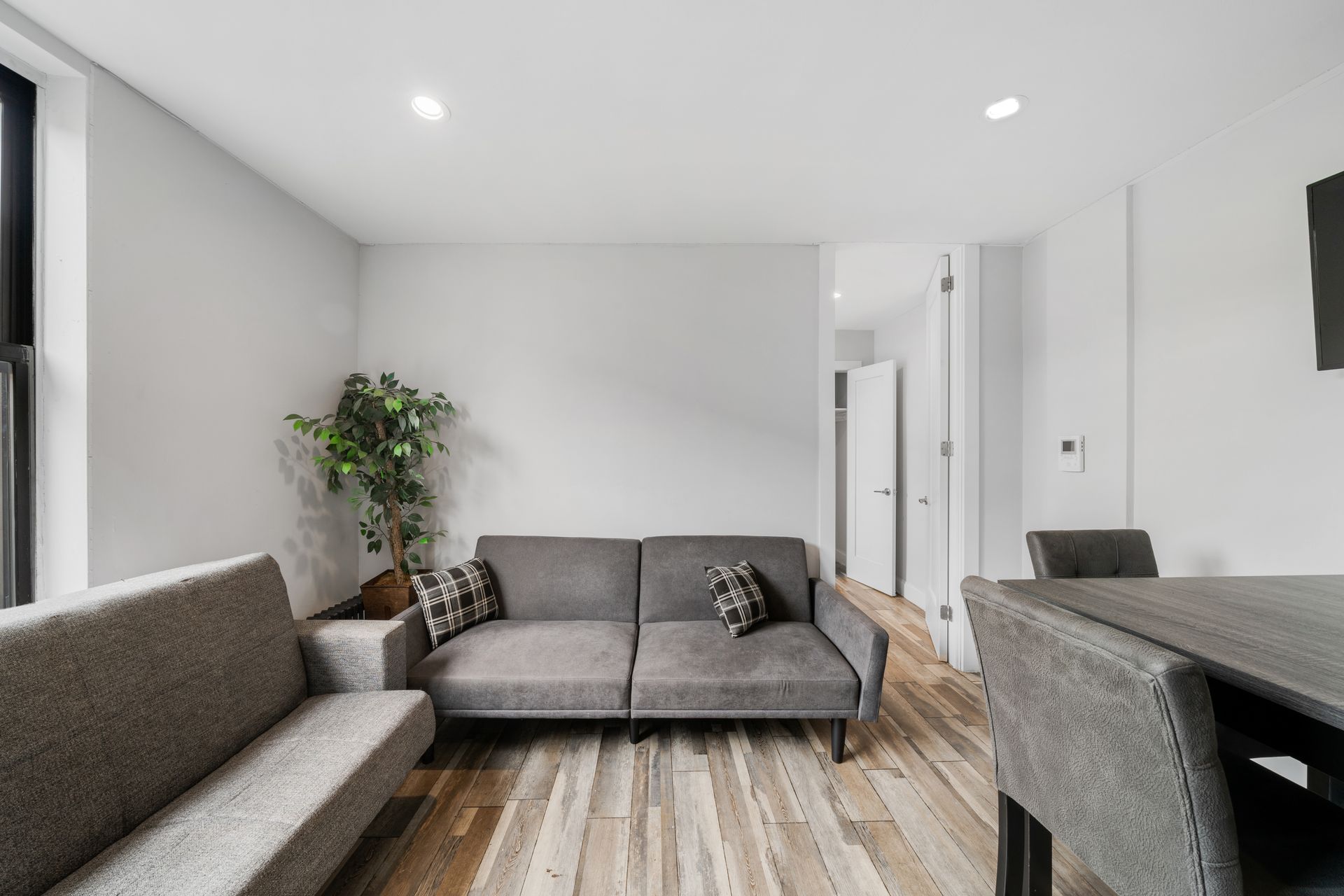 A living room with a couch , table and chairs