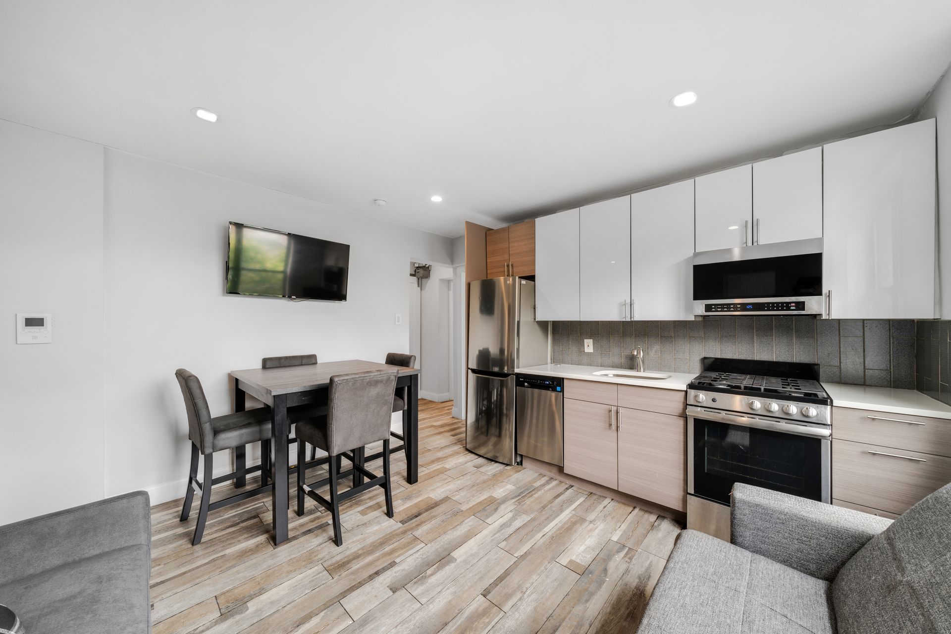 A kitchen with a table and chairs in it