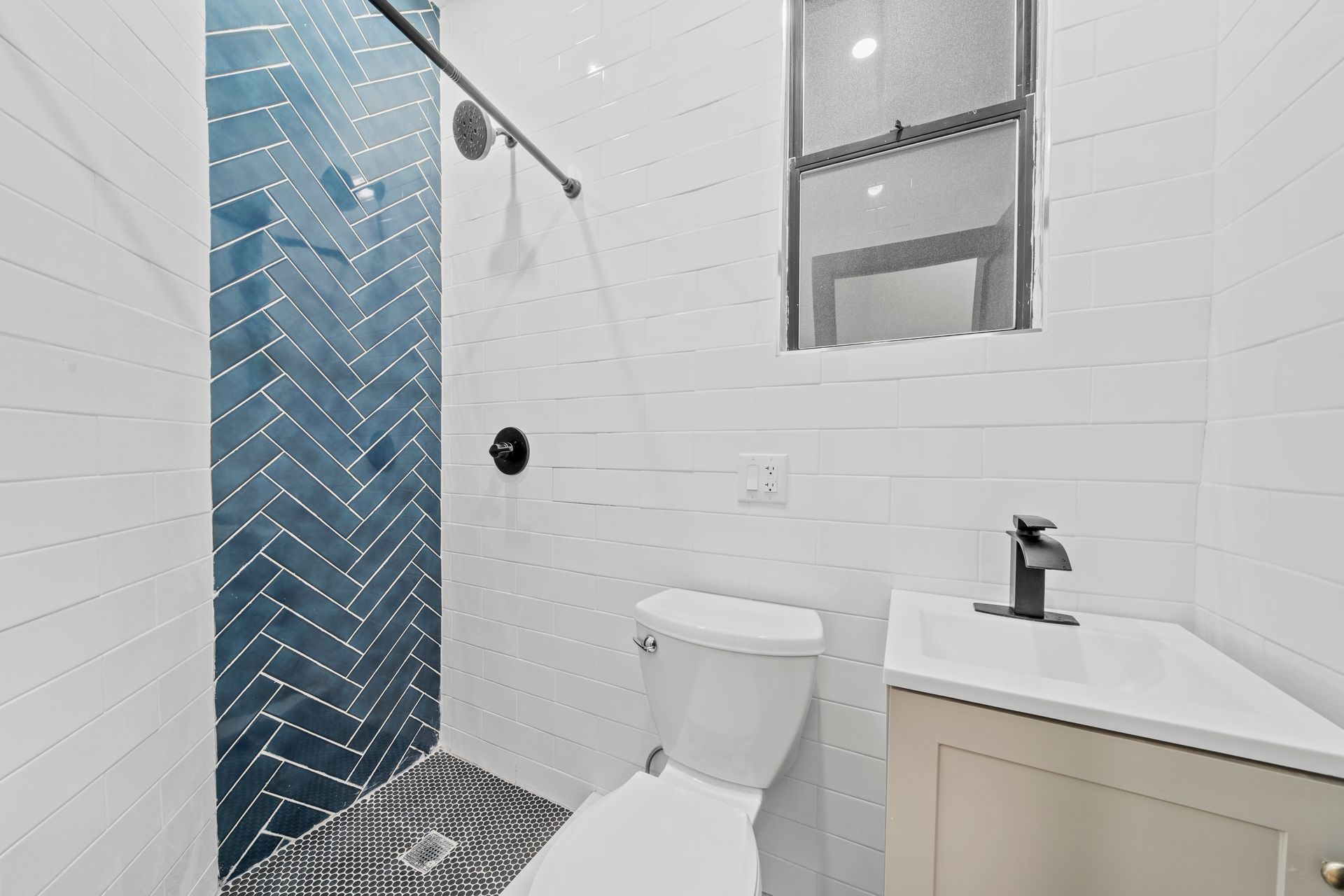 A bathroom with a toilet , sink , and shower.