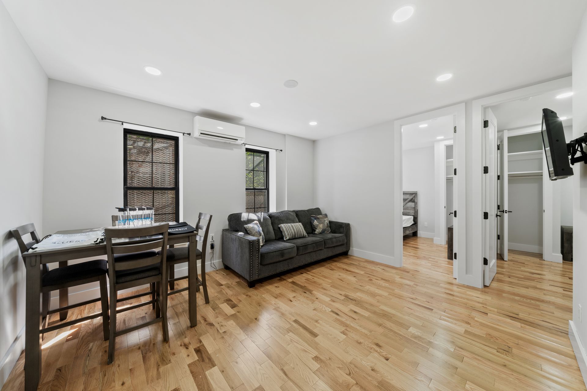 A living room with a couch , table and chairs.