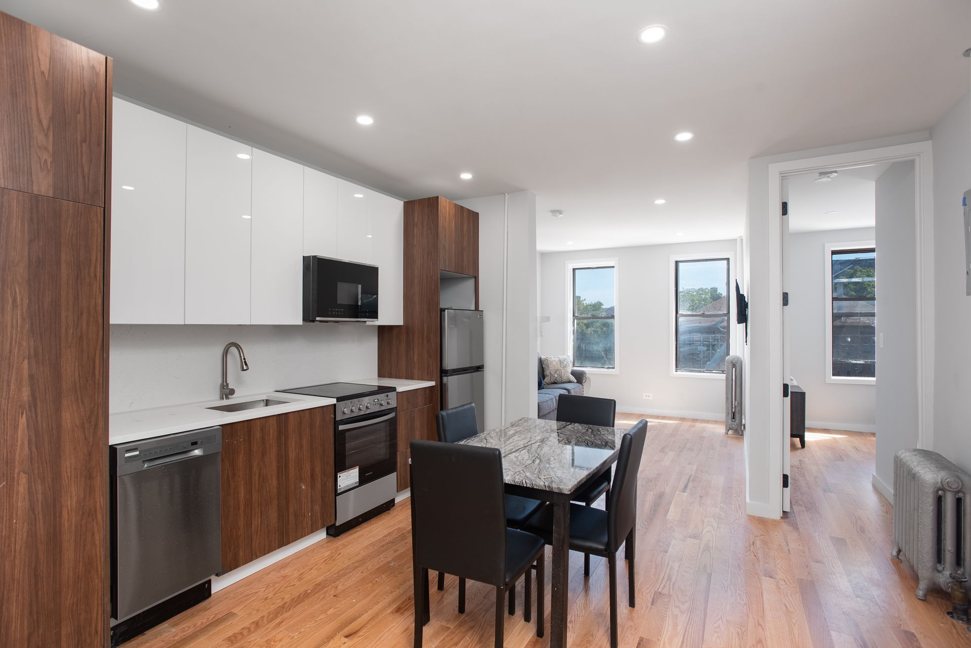 A kitchen with a table and chairs in it