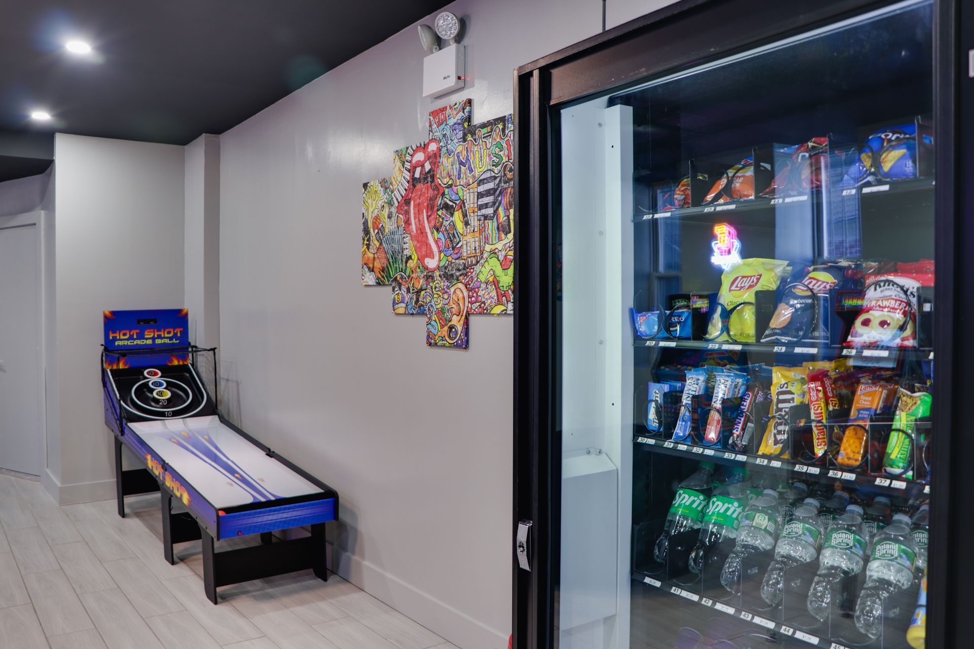 A room with a vending machine and a game table.