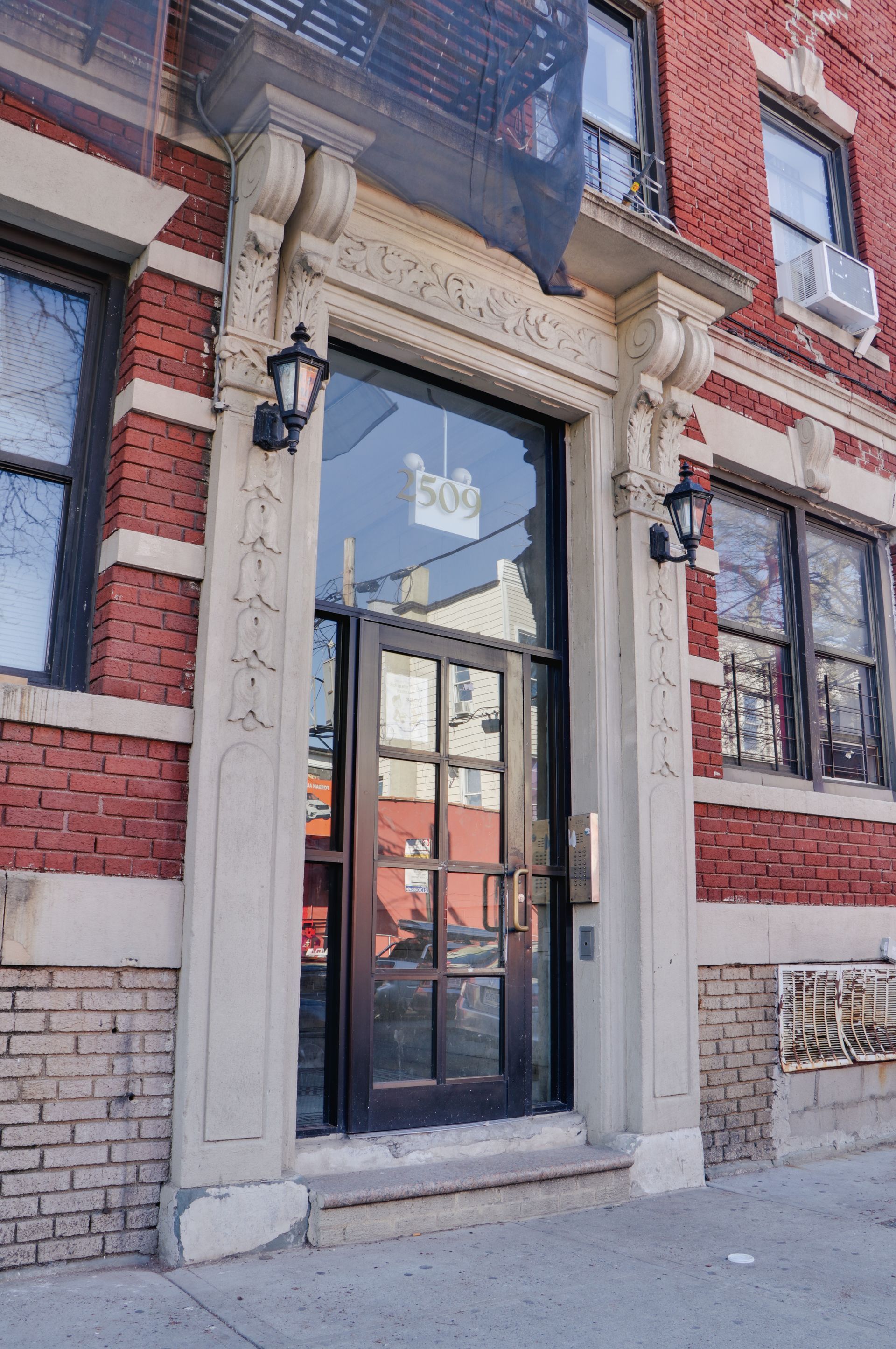 The front door of a brick building with a glass door