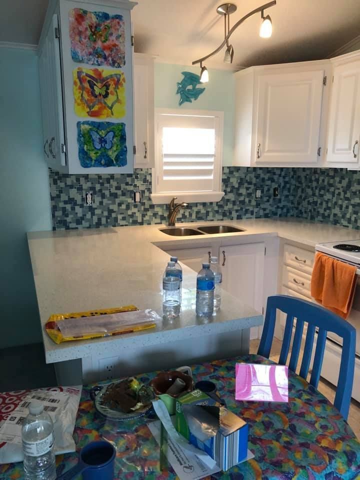 A kitchen with a table and chairs and a sink