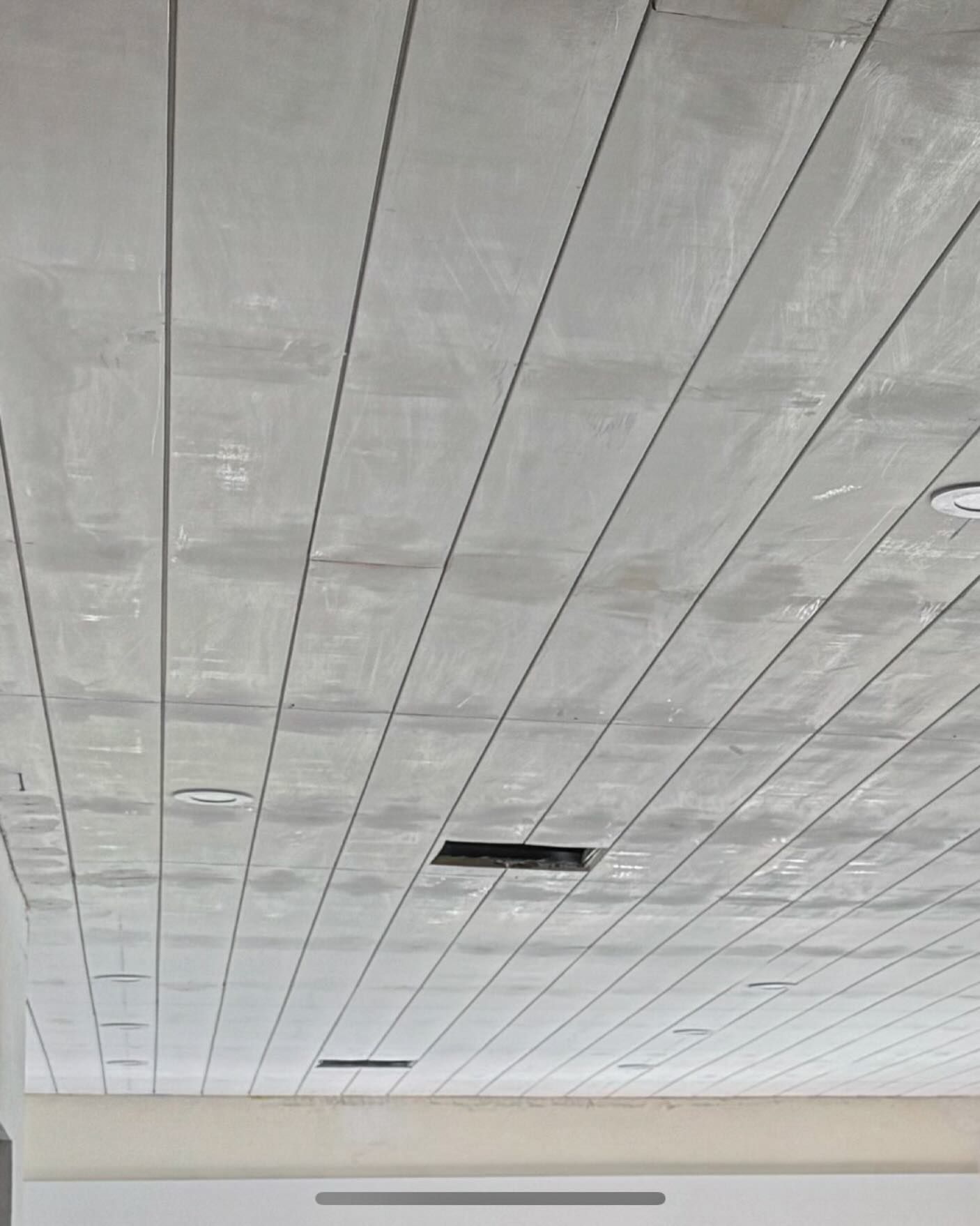 A close up of a ceiling with a hole in it.