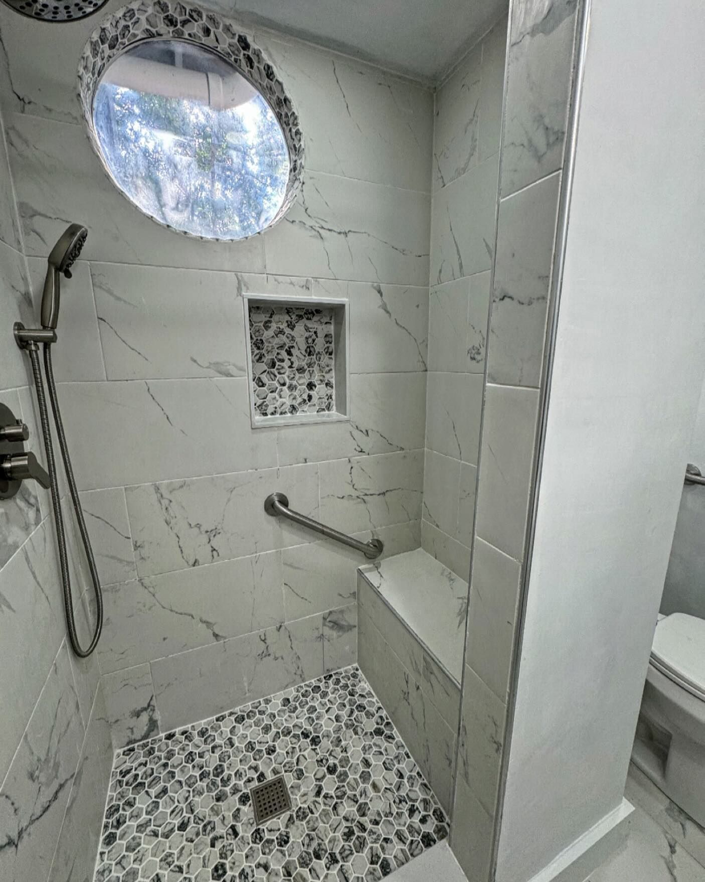 A bathroom with a walk in shower and a toilet.