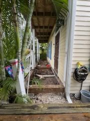 A wooden walkway leading to the front door of a house.